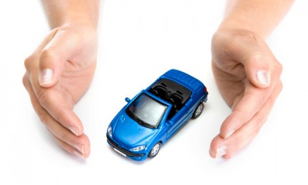 woman hands holding blue car isolated on white background